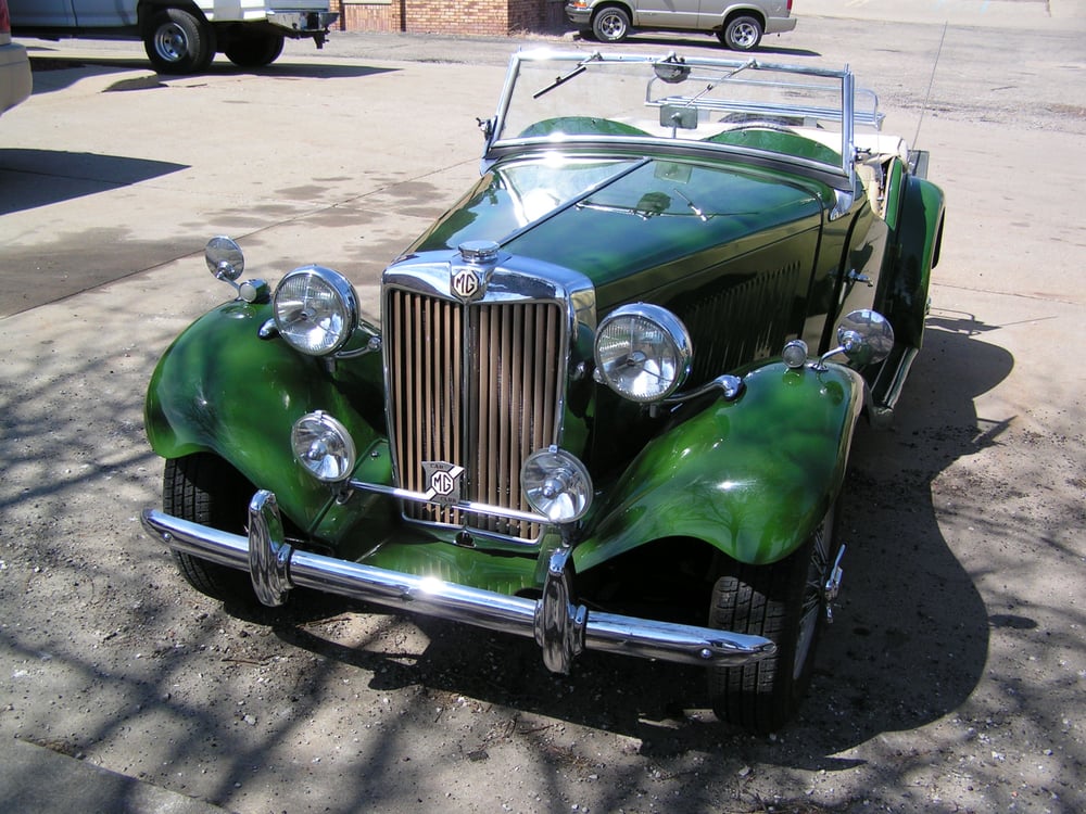 Delivered: deep metallic green MG T-series roadster with chrome bumpers and driving lamps