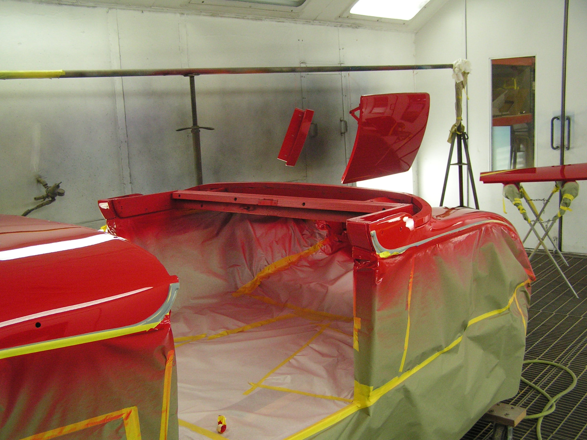 During: Auburn body panels sprayed deep red in the paint booth